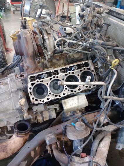 A diesel engine mid teardown at the shop, heads off with the cylinders exposed